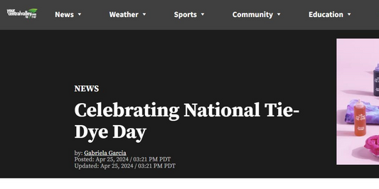 Black background screen shot of news article with headline "Celebrating National Tie Dye Day" and image with tie dye bottles and shirts with pink background